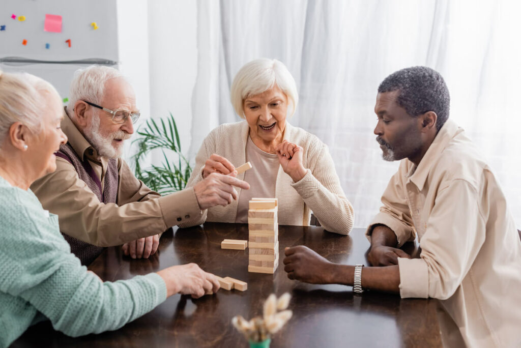 Cordata Court | Seniors playing a game with a tower of wood blocks