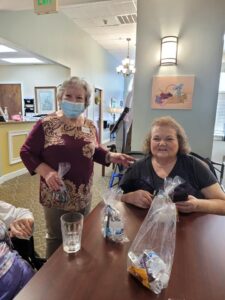Laketown Village | Residents smiling with goodie bags full of snacks