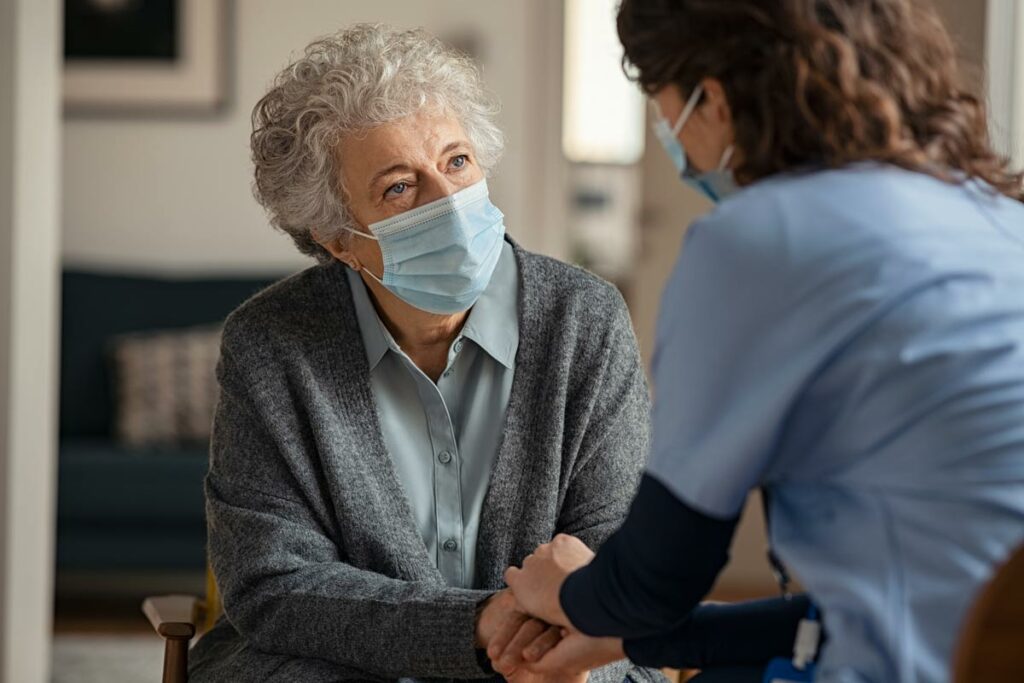 Lakeview of Kirkland | Associate comforting senior in mask