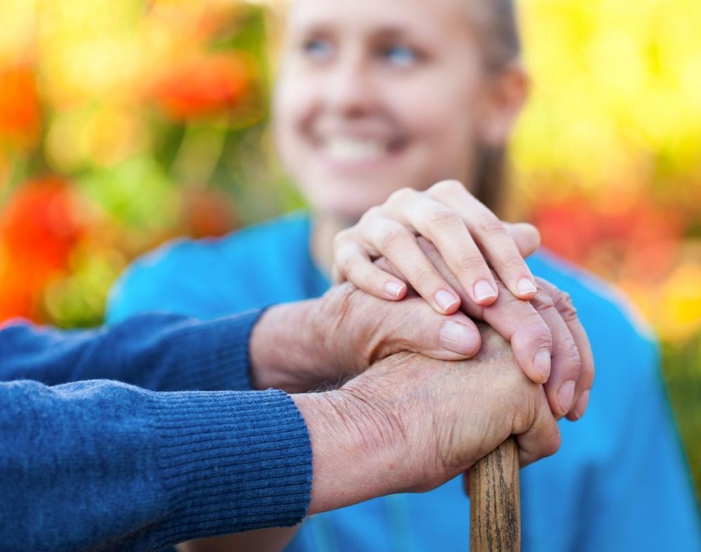 Pegasus Senior Living | Senior holding hands with caregiver
