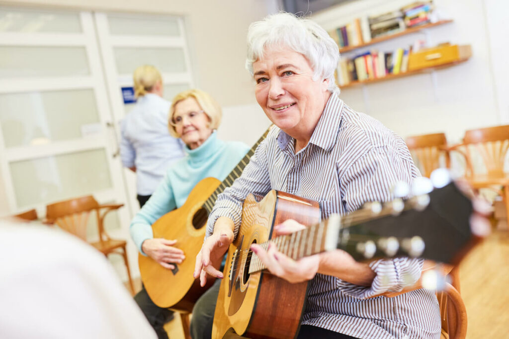 Pegasus Senior Living | Happy seniors playing guitar together