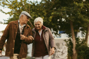 Belleview Suites at DTC | Happy senior couple walking outside and smiling