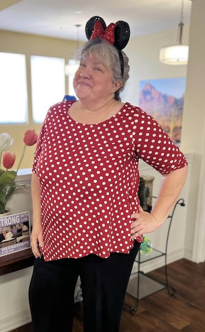 Broadway Mesa Village | Life Enrichment Director Teresa wearing Minnie Mouse ears