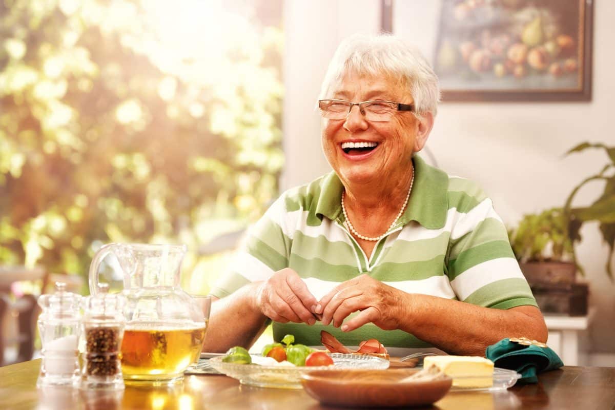 Broadway Mesa Village | Senior woman eating breakfast