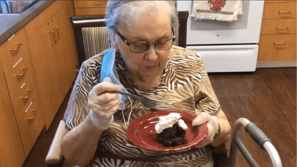 Broadway Mesa Village | Resident Eating Cake