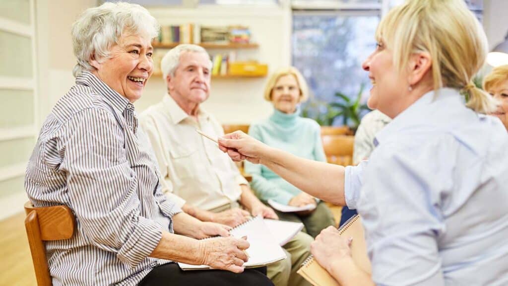 Broadway Mesa Village | Group of happy seniors playing a group memory care game