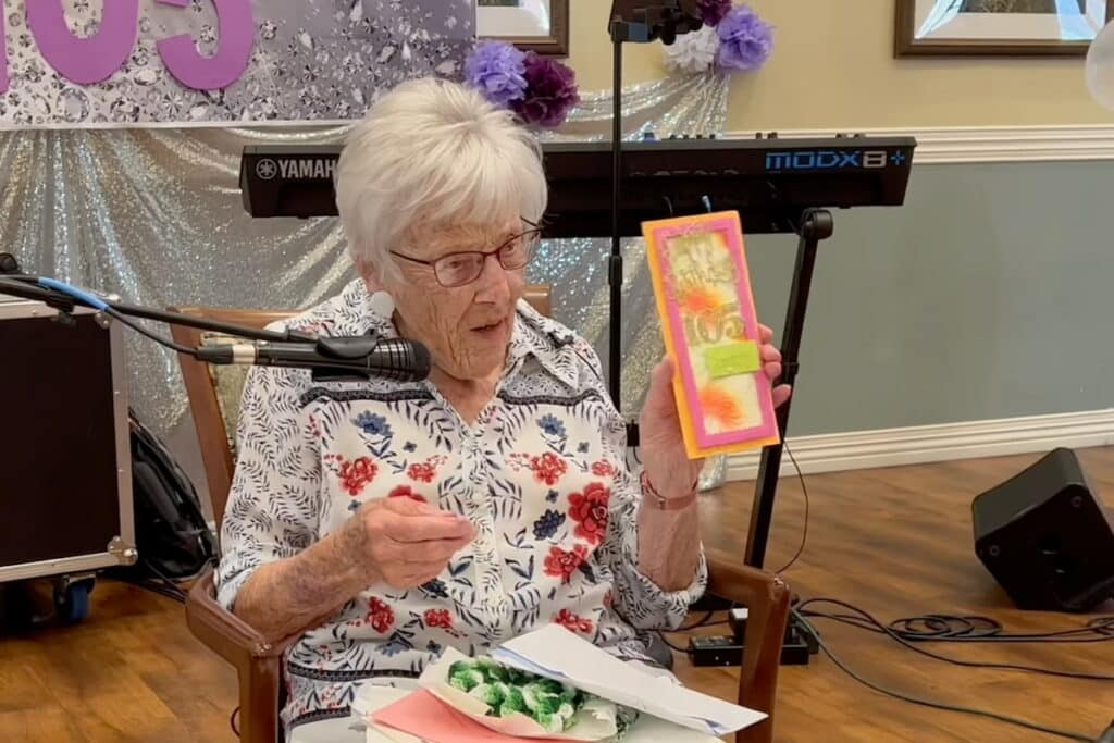 Broadway Mesa Village | Senior resident showing her birthday cards