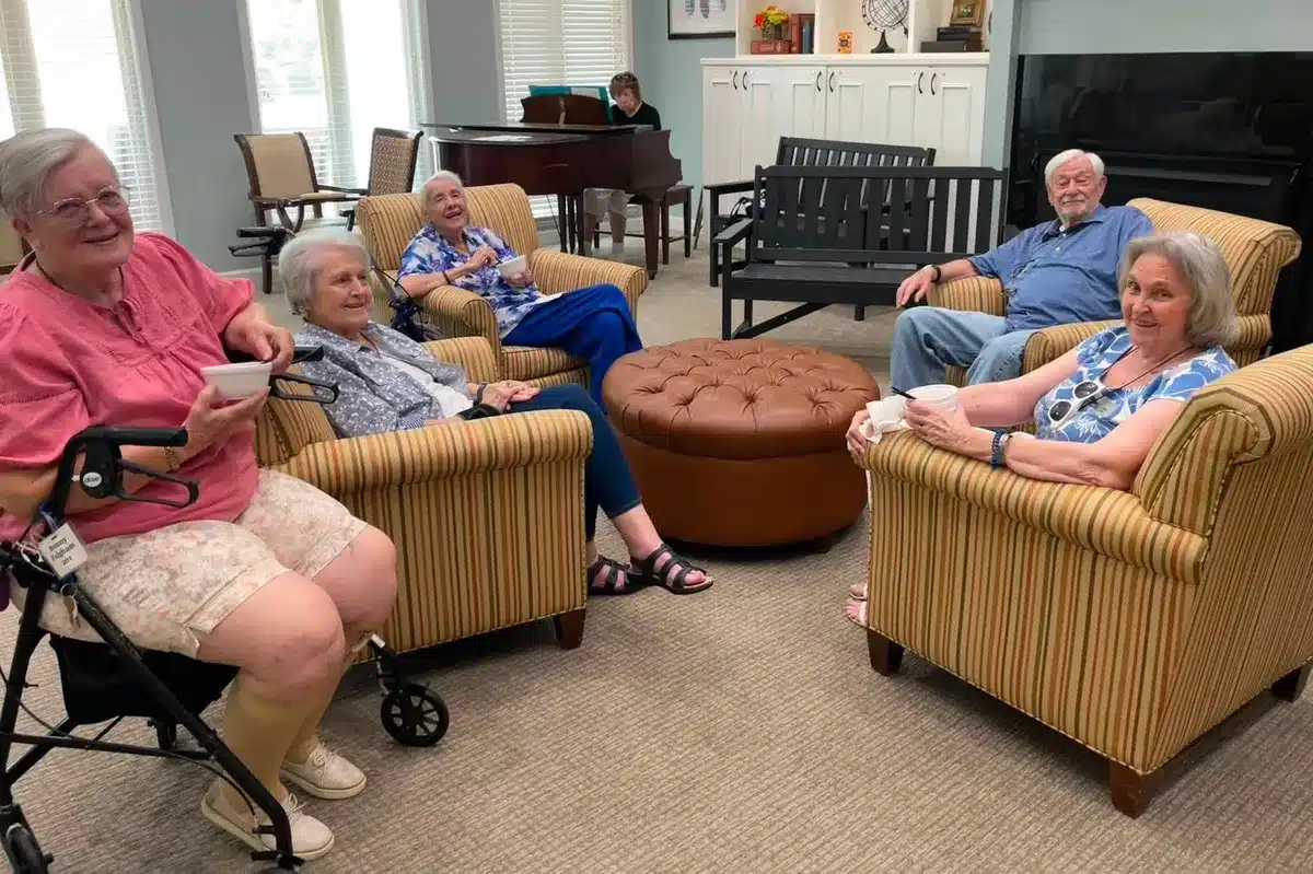 Resident socializing and smiling in the common room
