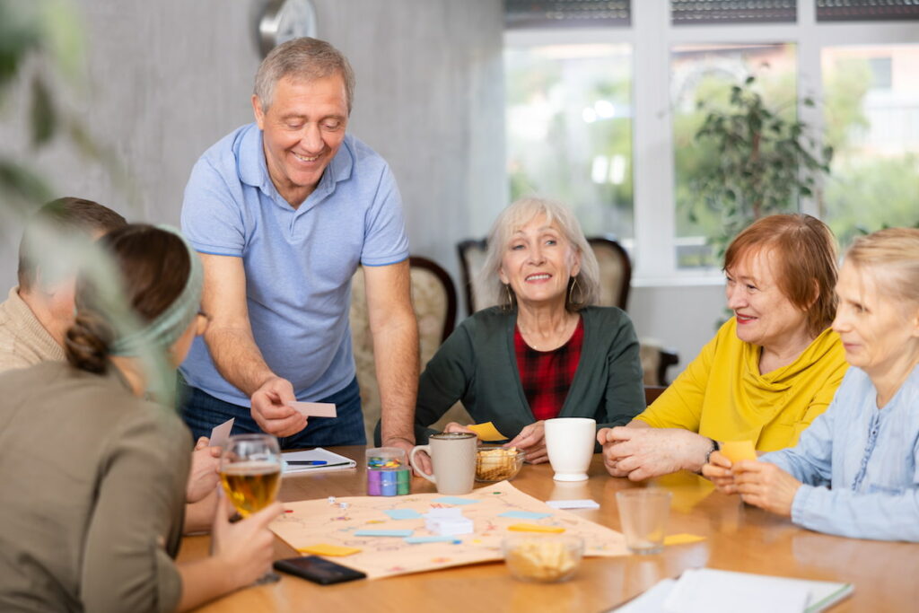 Cordata Court | Seniors enjoying activities at the table together