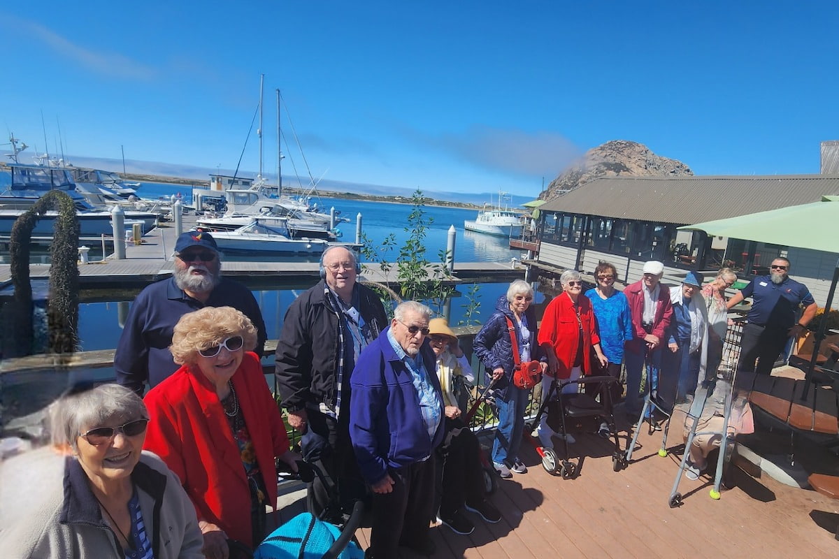 Creston Village | Seniors taking a photo by the lake during a day trip