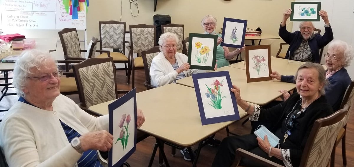 Creston Village | Residents with paintings