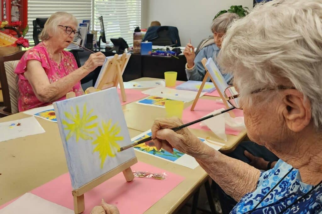 Creston Village | Seniors painting flowers