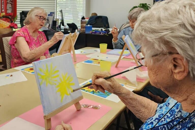 Creston Village | Seniors painting flowers