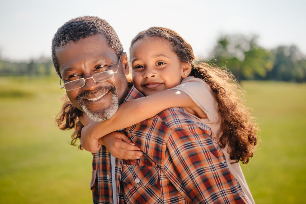 Dunwoody Place | Senior giving granddaughter a piggyback ride