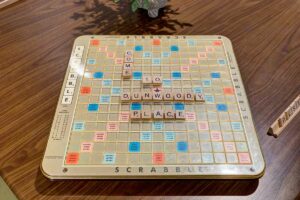 Dunwoody Place | Scrabble board with letters that spell Come to Dunwoody Place