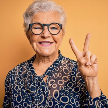 Dunwoody Place | Senior woman holding up two fingers