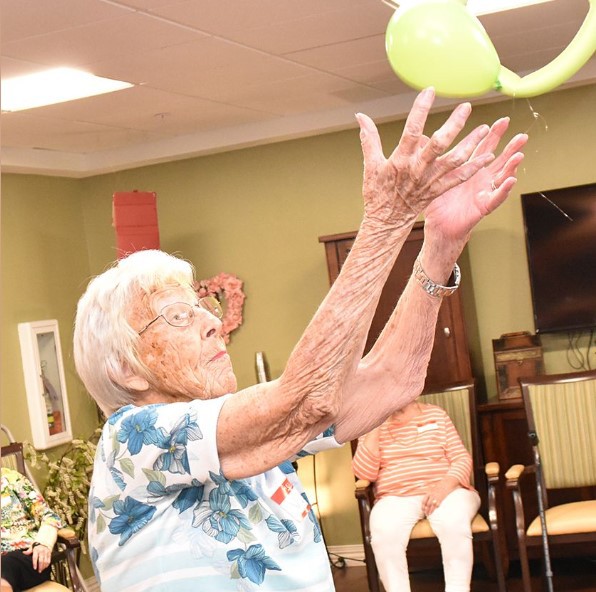 Pegasus Senior Living | Senior residents playing with a ball
