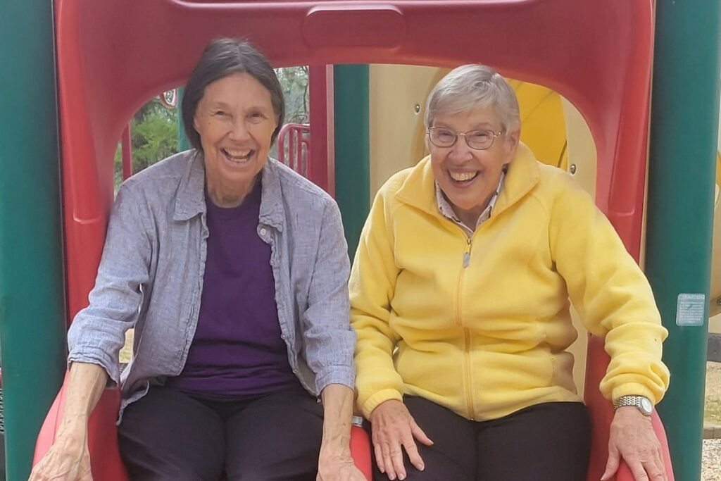Pegasus Senior Living | Two friends on a slide