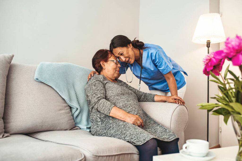 Gig Harbor Court | Senior woman talking with her caregiver while sitting on the couch