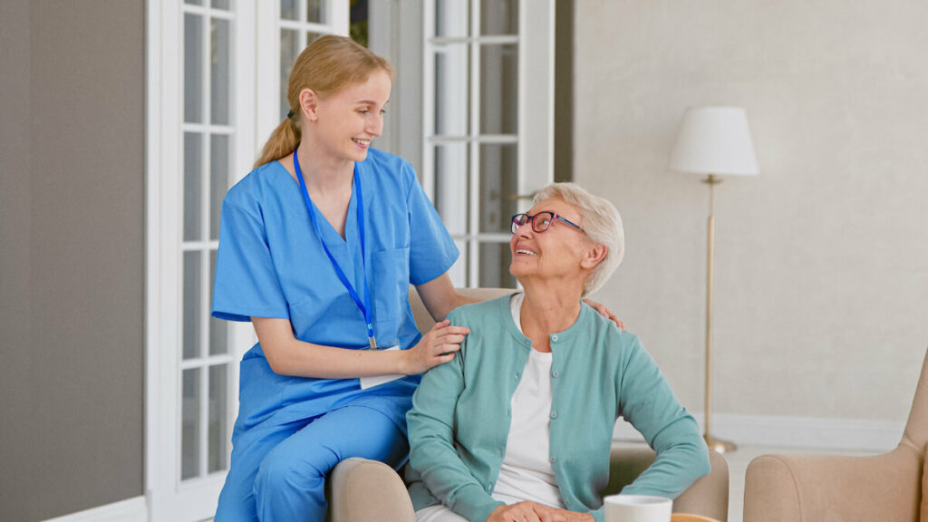 Gig Harbor Court | Senior woman talking with her caregiver while sitting on the couch