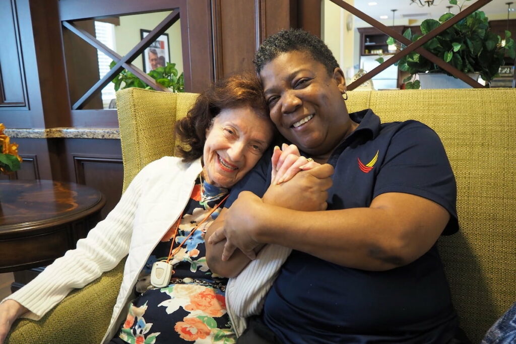 Pegasus Senior Living | Senior resident and staff member hugging