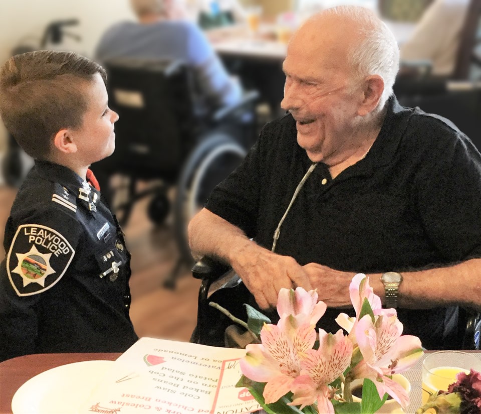 Glenwood Village of Overland Park | Senior speaking to child in costume