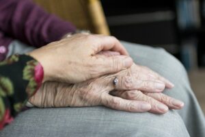Glenwood Village of Overland Park | Senior holding hands with caregivers