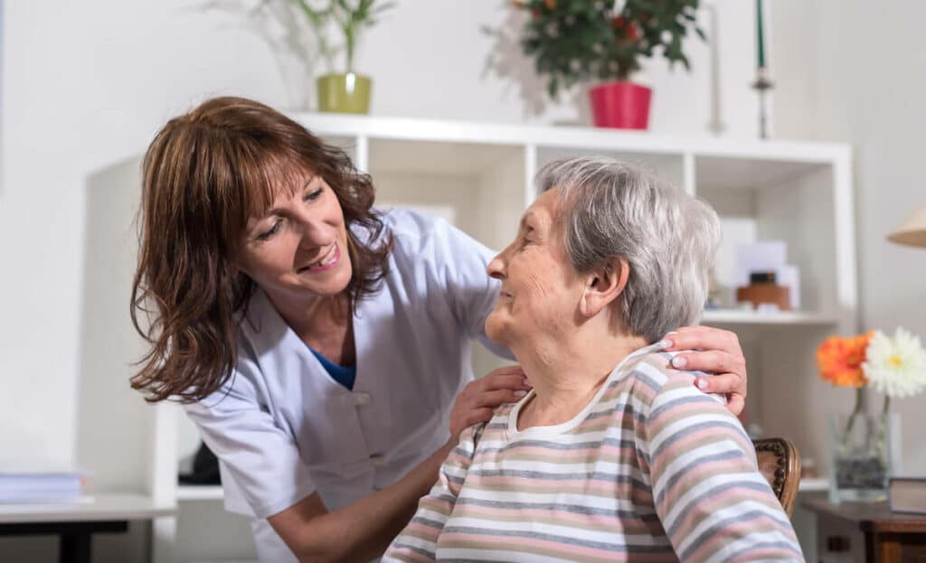 Glenwood Village of Overland Park | Senior woman being comforted by her caregiver