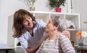 Glenwood Village of Overland Park | Senior woman being comforted by her caregiver