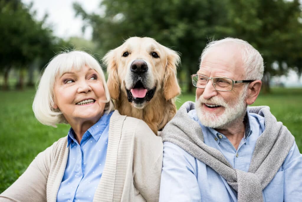 Pegasus Senior Living | Senior couple hanging out outside with their dog