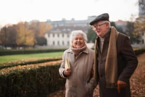 Glenwood Village of Overland Park | Smiling senior couple out for a walk in chilly weather