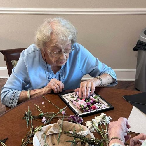 Glenwood Village of Overland Park | Senior woman creating floral craft