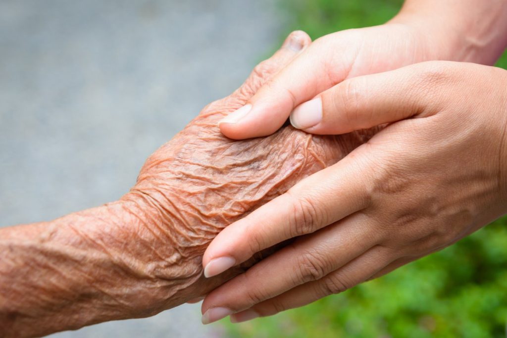 Greenhaven Place | Senior holding hands with caregiver