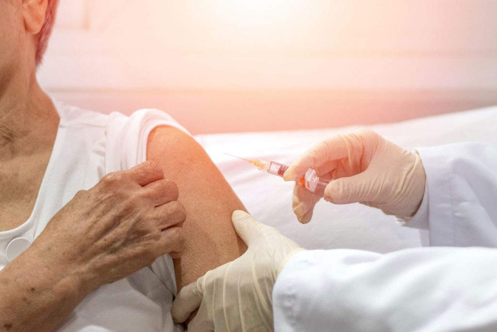 Greenhaven Place | senior woman receiving a flu shot