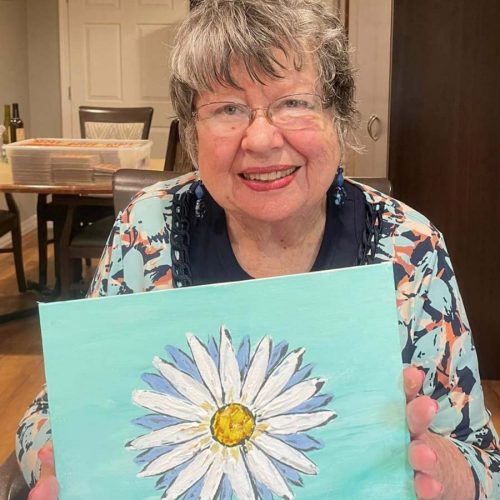 Greenhaven Place | Senior woman holding painting of flower