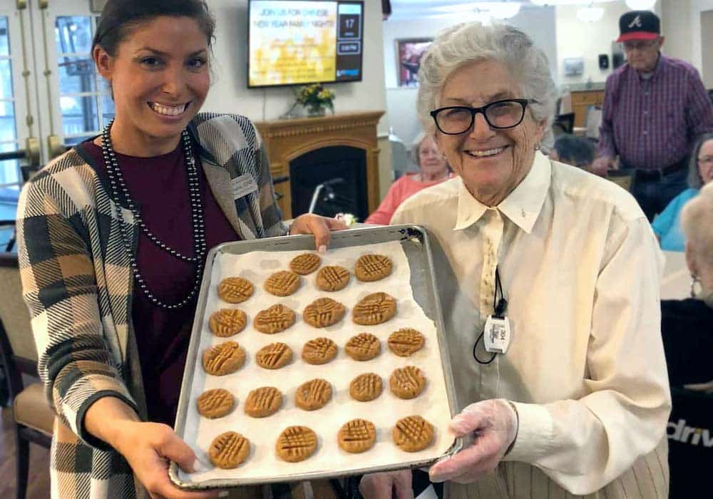 Historic Roswell Place | Senior woman baking with associate