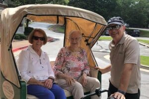 Historic Roswell Place | Mountain Park senior living community residents sitting in a pedicab