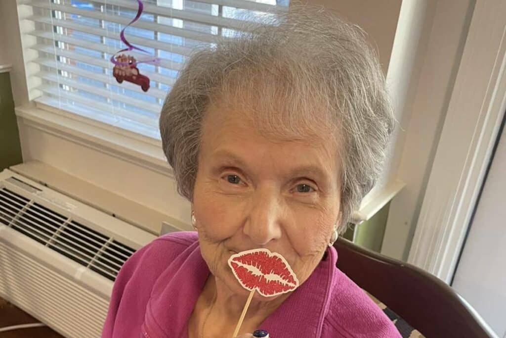 Historic Roswell Place | Senior resident holding up fake lips