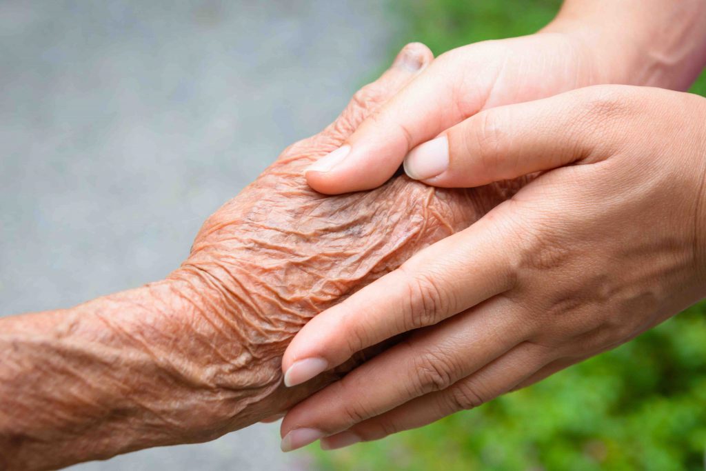 Laketown Village | Senior holding hands with caregiver
