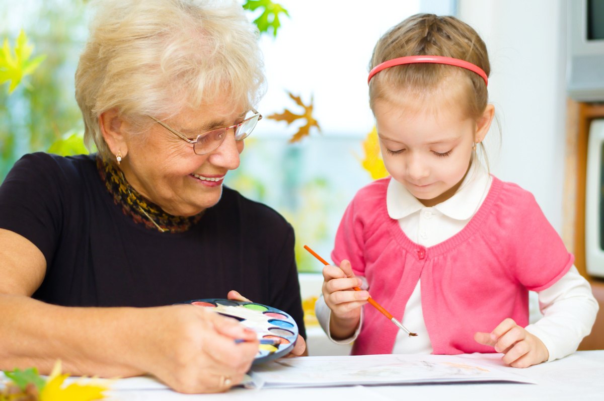Laketown Village | Senior woman drawing with young girl