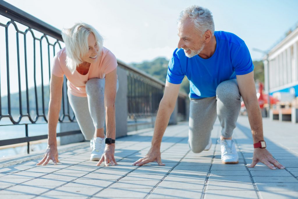 Laketown Village | Two seniors lunging, preparing for a race