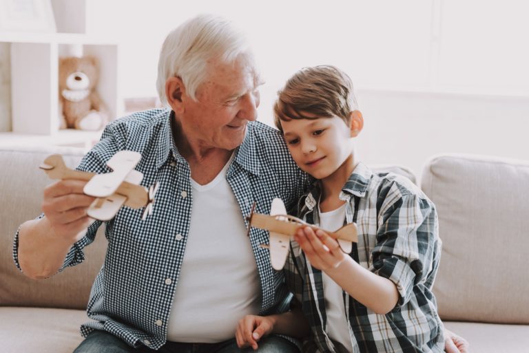 Laketown Village | Senior flying model planes with his grandson