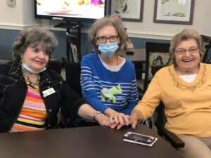 Laketown Village | Three residents holding hands