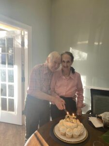 Laketown Village | Senior residents Rose and Earl lighting 65th anniversary candles together