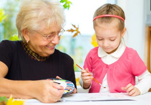 Laketown Village | Senior woman drawing with young girl