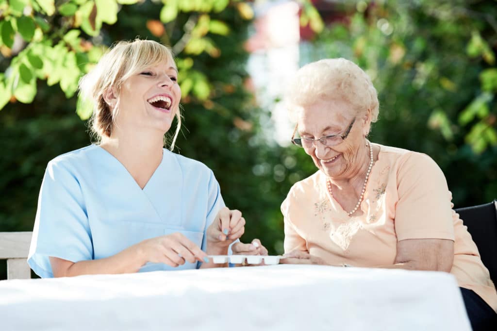 Magnolia Place of Roswell | Senior laughing with caregiver