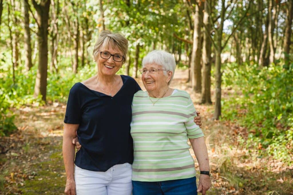 Magnolia Place of Roswell | Daughter embracing senior mother with dementia on summer day
