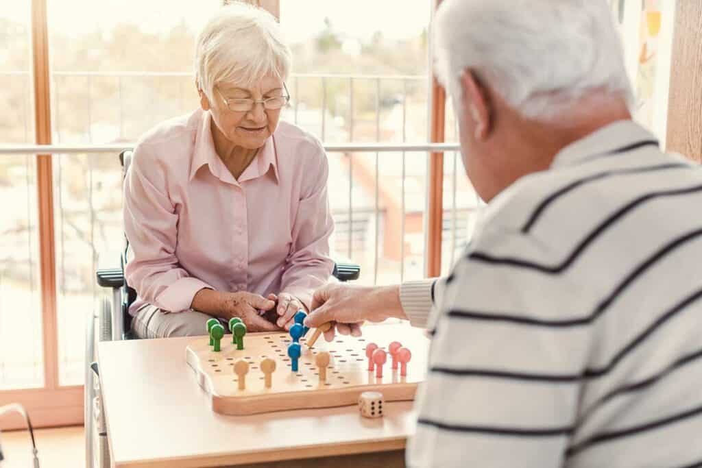Magnolia Place of Roswell | Two seniors in a nursing home playing a board game