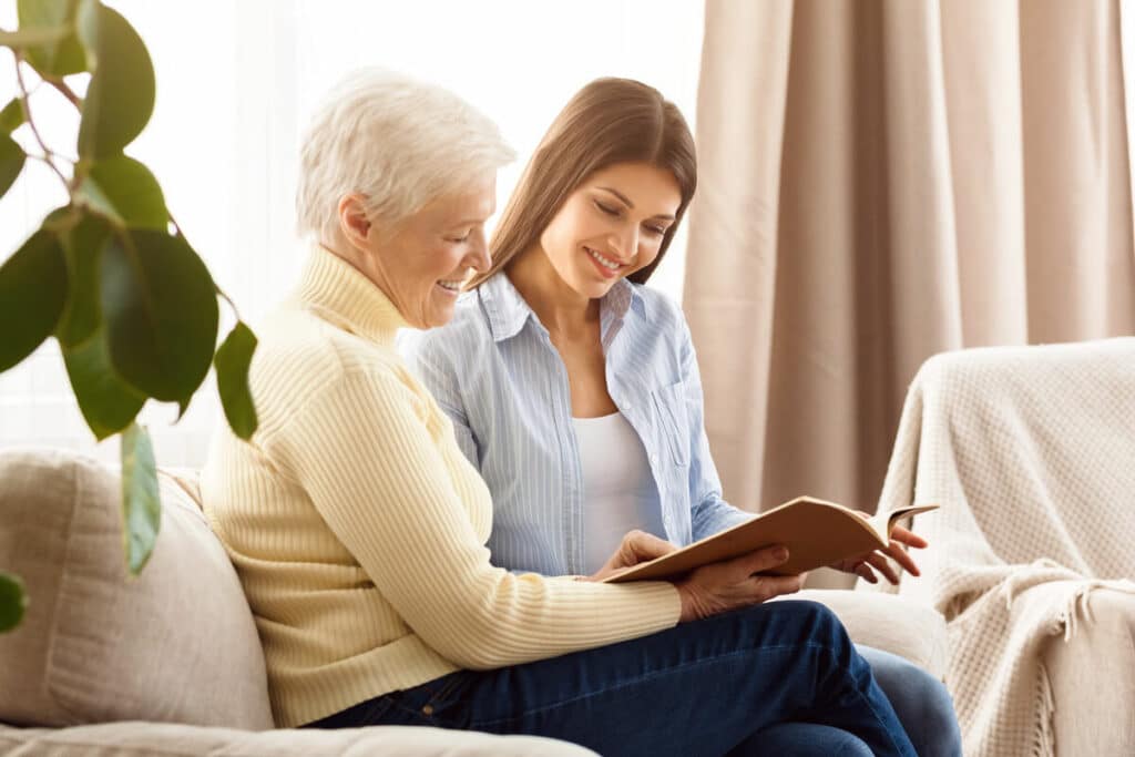 North Point Village | Happy senior and granddaughter looking through book together