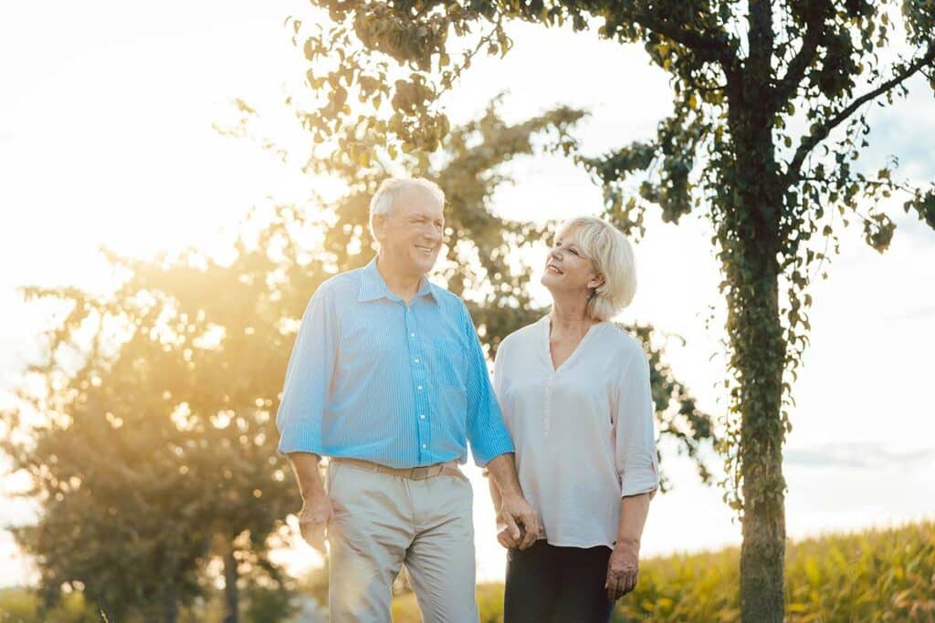 Parmer Woods at North Austin | Happy senior couple walking outside holding hands